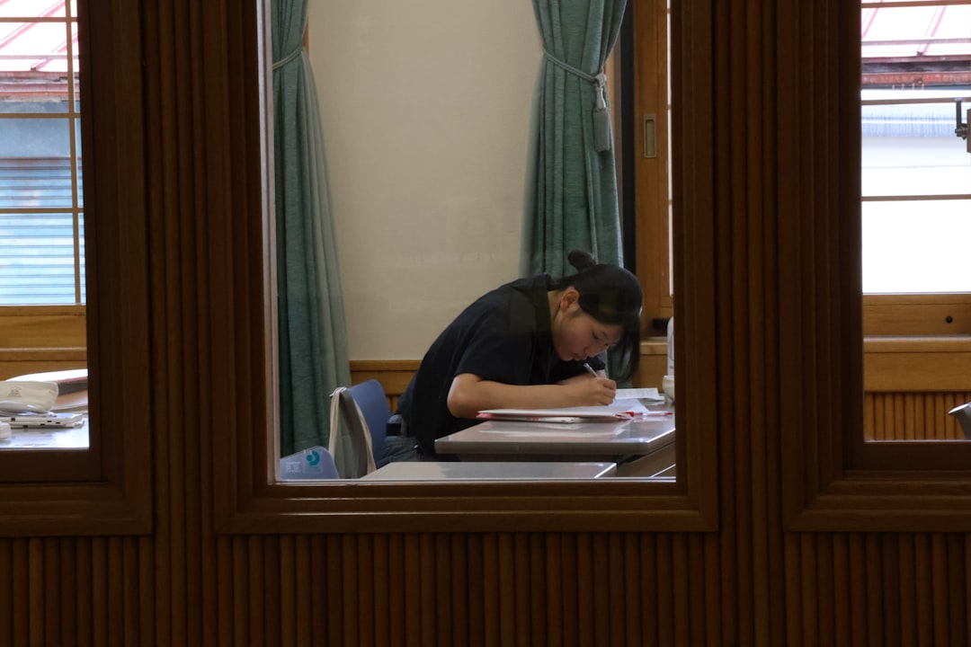 Person studying at a desk with books, illustrating why students resist active recall and prefer passive reviewing.