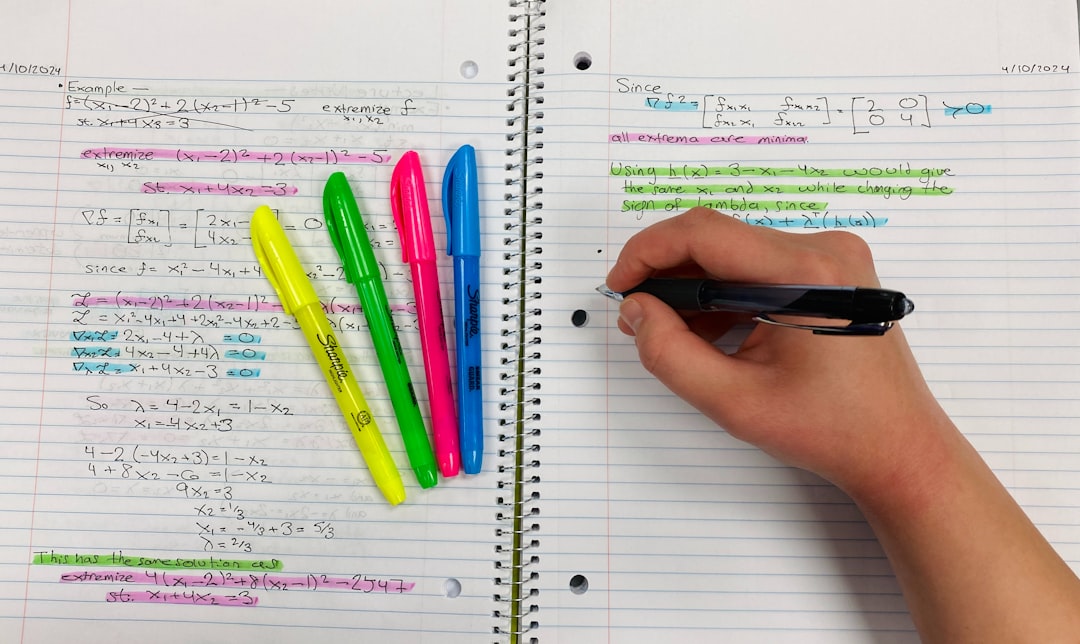 Hand taking notes with colorful highlighters, representing targeted SAT section strategies and focusing on high-impact skills.