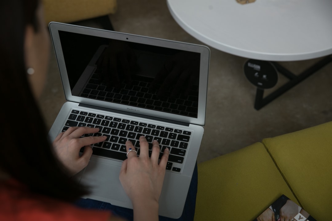Woman typing on a laptop at a table, illustrating creating a skills portfolio with tangible proof and documented work.
