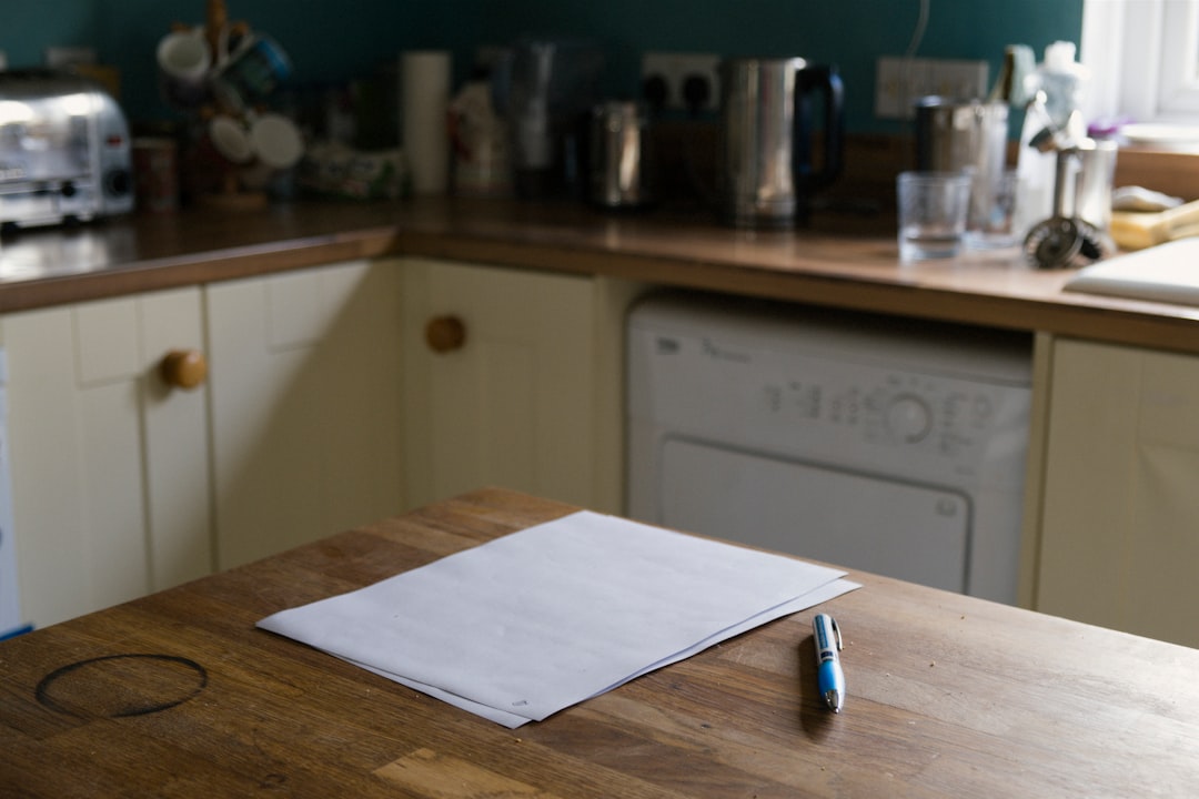 Pen and paper on a kitchen table, reflecting quick weekly actions to plan, practice, and track skill-building.
