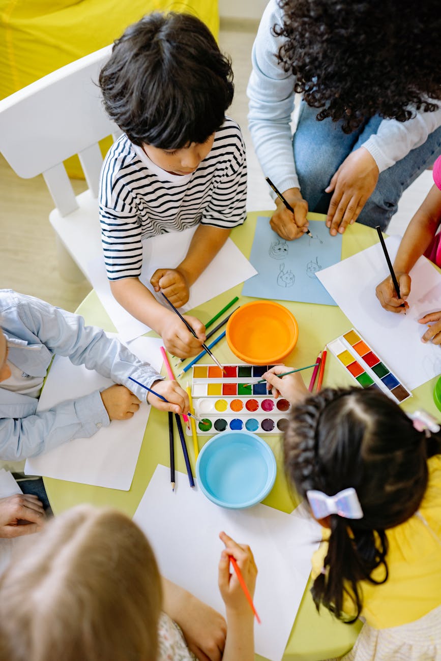 Children painting with watercolors at a preschool art class