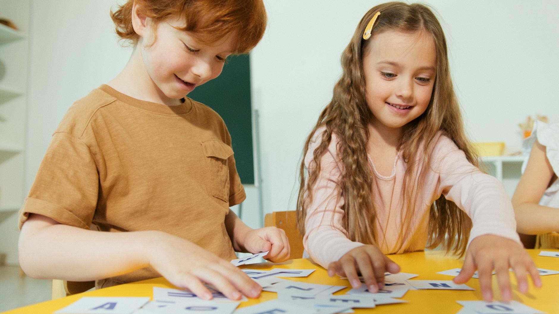 Happy children engaged in learning with educational flashcards in a classroom